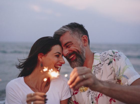 couple with sparklers at the beach