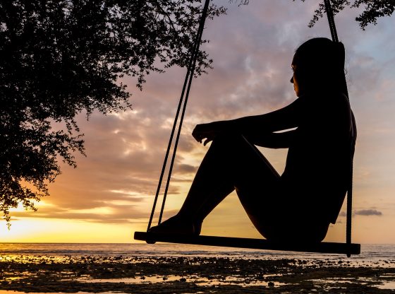 woman reflecting on swing