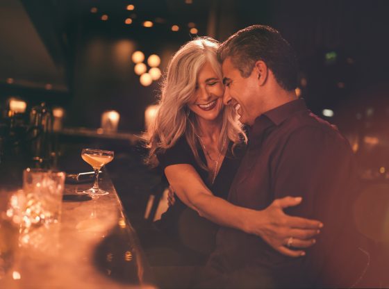 Elegant mature couple having fun on romantic date at bar