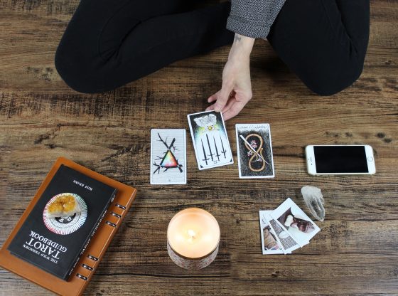 woman sitting with tarot cards