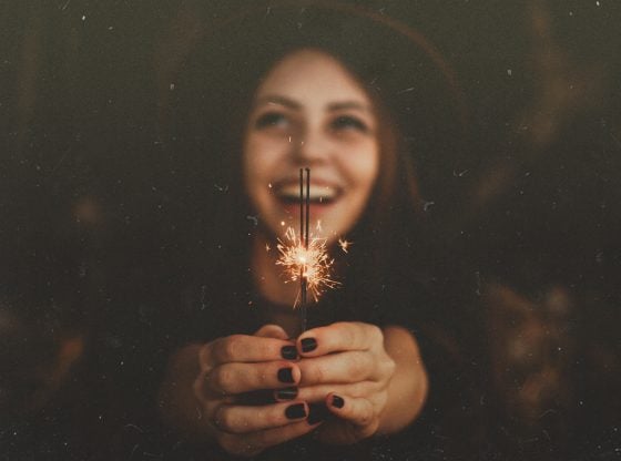 happy woman holding sparkler