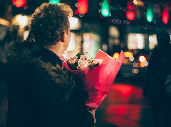 man holding bouquet of roses