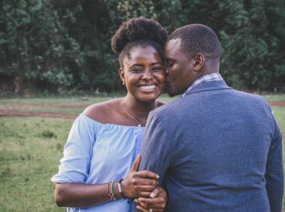 man kissing woman on the cheek