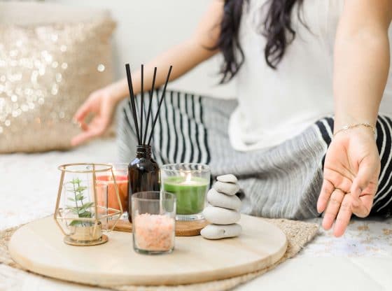 A woman meditates to balance her chakras